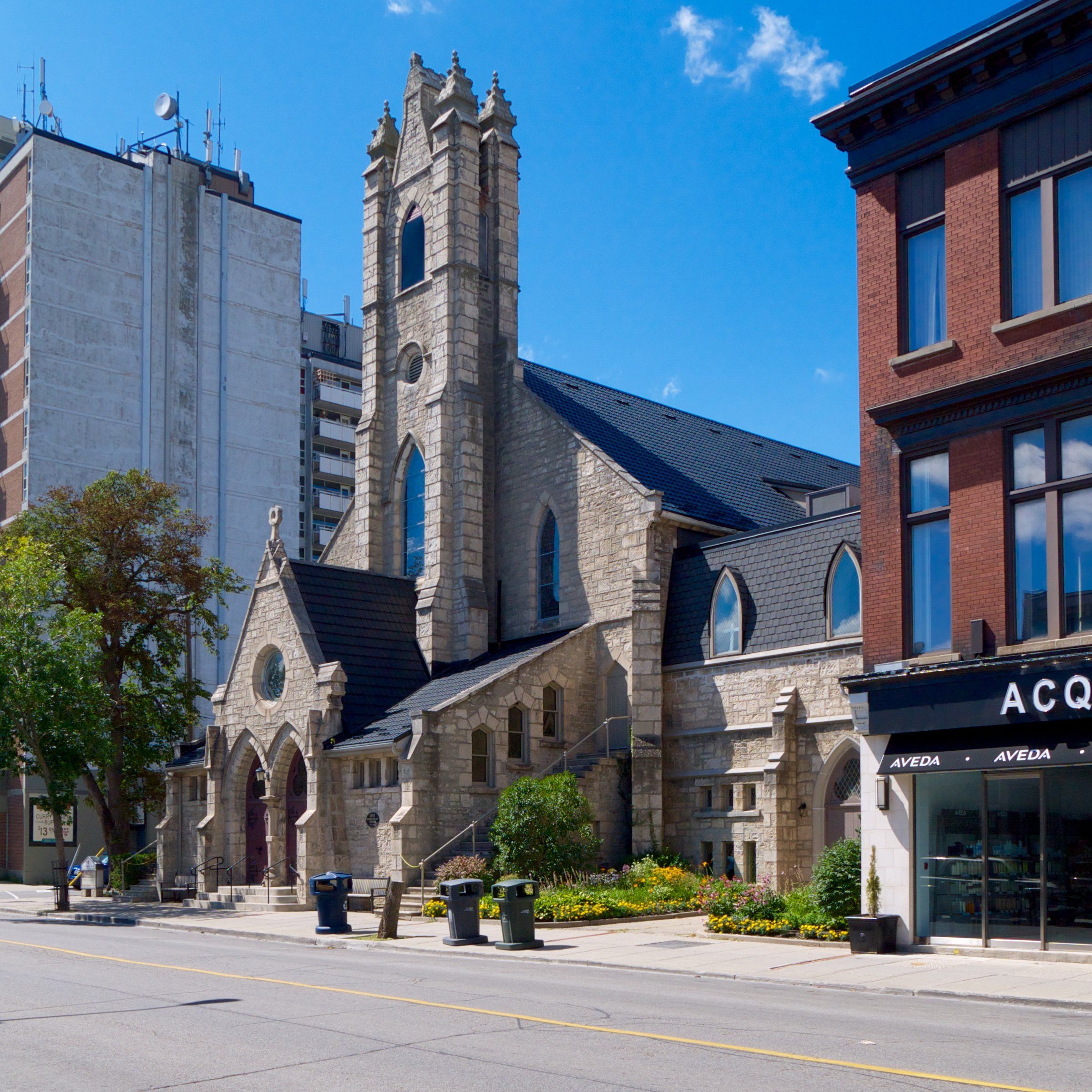 Knox Presbyterian Church, a grey stone church with a square tower on a downtown street corner