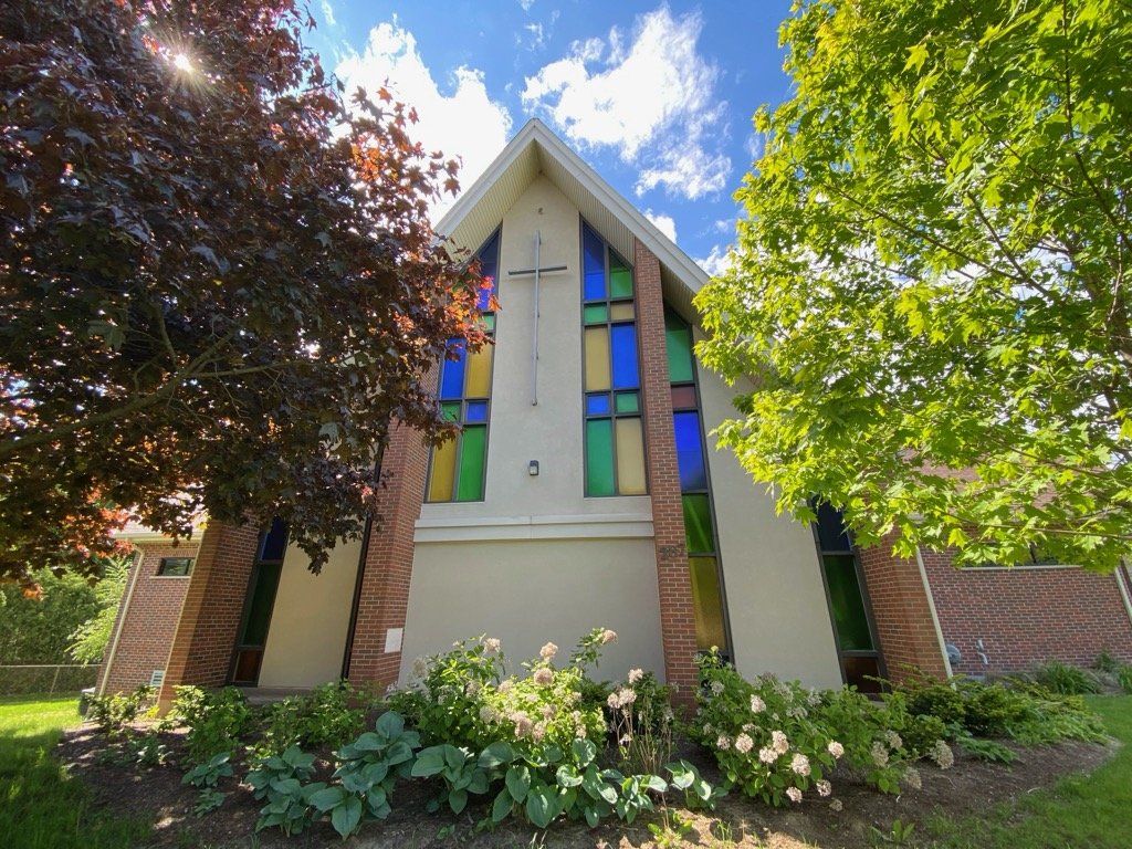 The front of Water Street Church, with coloured glass and a cross in its peaked facade